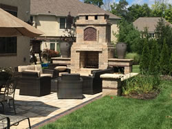 The outdoor living area with the paver patio and fire pit